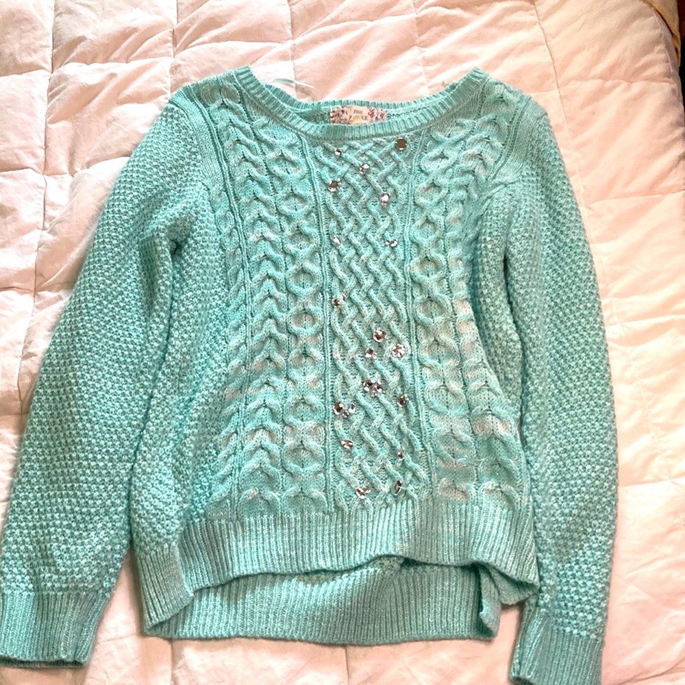 A blue sparkly sweater